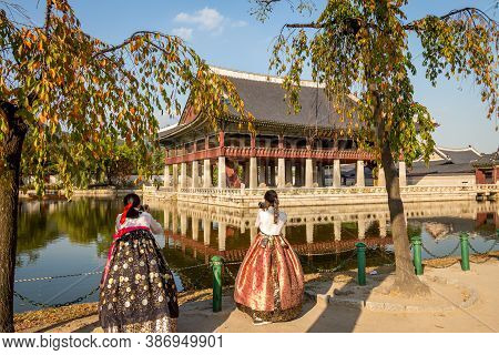 Seoul, South Korea - October 19th 2017: Women Dressed In Hanbok Traditional Dresses By The Lake At G
