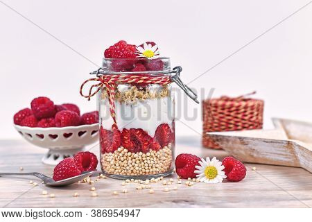 Healthy Raspberry Fruit Dessert With Skyr Yogurt,  Granola And Puffed Quinoa Grains Layered In Jar S