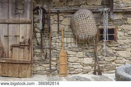 A House Facade With Historic Agricultural Equipment