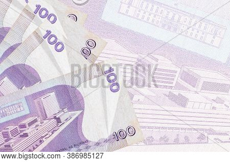 100 Philippine Piso Bills Lies In Stack On Background Of Big Semi-transparent Banknote. Abstract Bus