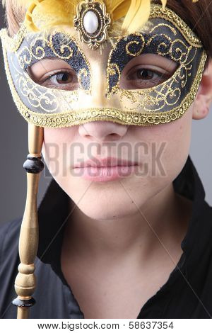 Elegant girl with a wonderful mask studio shot