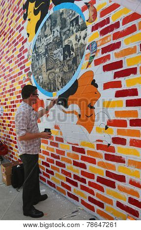 French street artist Franck Duval painting mural at Williamsburg
