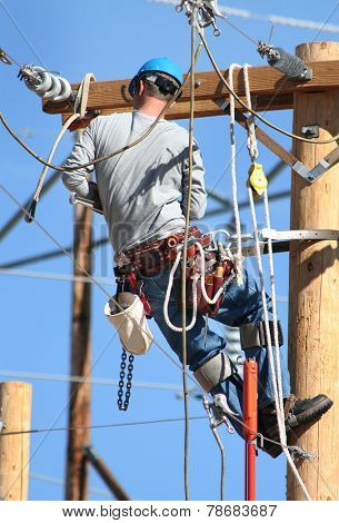 an electrical lineman working on lines
