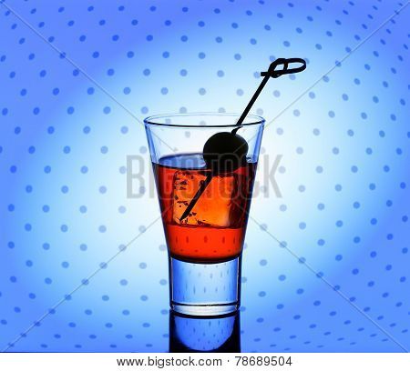 Short Drink Glass With Red Liquid And Ice Cubes