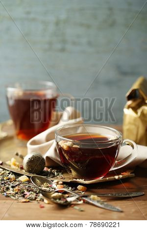 Beautiful vintage composition with herbal tea, on wooden table
