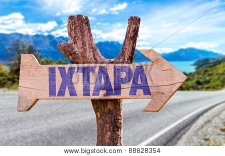 Ixtapa wooden sign with road background