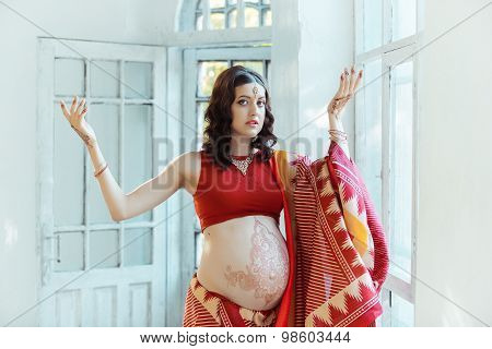 The pregnant woman belly with henna tattoo