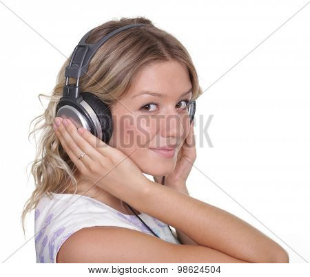 Happy young blonde woman listening to music, isolated on white