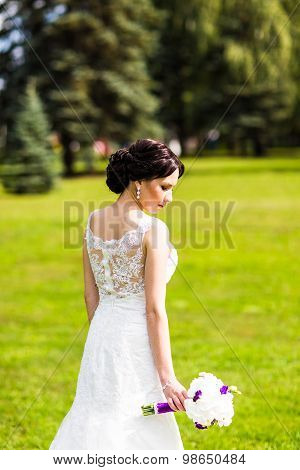 Beautiful bride in wedding dress and bridal bouquet