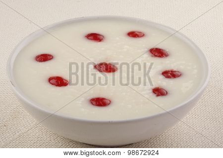 Rice porridge with red plums and honey.