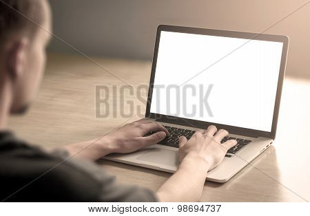 Man using laptop with blank screen - mockup template