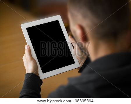 The person using the digital tablet in living room