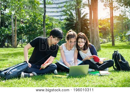 Young Student Asian Group Teenager with school folders on grass at university campus college