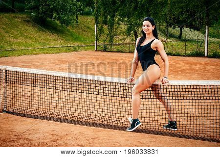 A Beautiful Young Free Sports Sexy Girl Dressed In Bodysuit, Sneakers And Sunglasses, With A Smart A