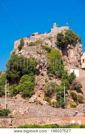 The Mountain Town Of Pratdip In Spain. Copy Space For Text. Isolated On Blue Background. Vertical.