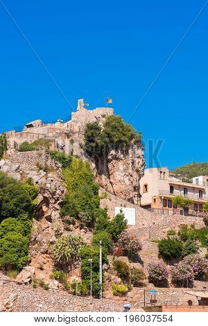 The Mountain Town Of Pratdip In Spain. Copy Space For Text. Isolated On Blue Background. Vertical.