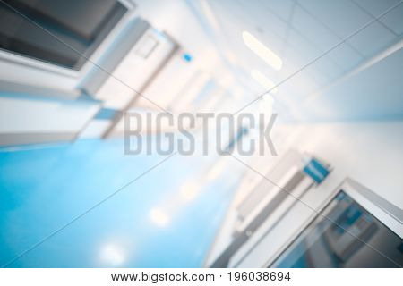Leaving blurres silhouette i hosptal corridor unfocused background.