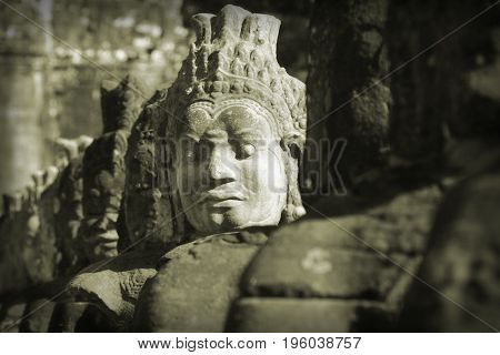Statues guarding the bridge to Angkor Thom Cambodia