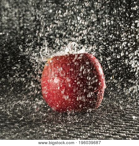 a fresh red apple in the rain
