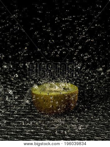 a half of a kiwi lying in the rain
