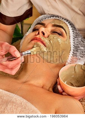 Collagen face mask. Facial skin treatment. Face of woman of elderly woman 50-60 years old receiving cosmetic procedure in beauty salon close up. The best curative clay for cosmetic masks.