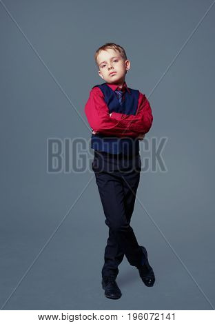 displeased child isolated against grey background