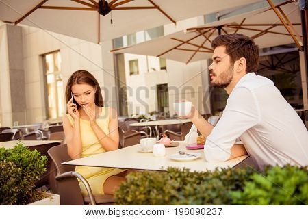 Relationship Problems. Lady Is Talking Very Quiet On Her Smart Phone, Covering Her Mouth With The Pa