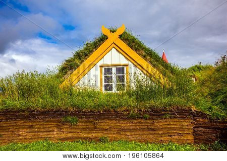  Interesting ethnographic museum Glaumbaer in Iceland. Facade of the farmhouse and outbuildings, covered with grass. The concept of the historical and cultural tourism