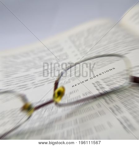 review questions electronic engineering book reading with glasses on open page
