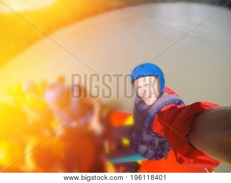 male athlete in the water on a boat is photographed for action in the summer. Concept group of people riding on rafting