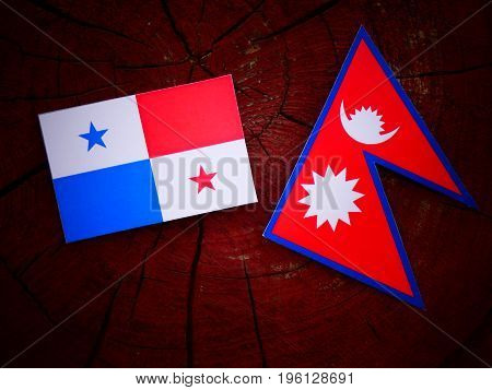 Panamanian Flag With Nepali Flag On A Tree Stump Isolated