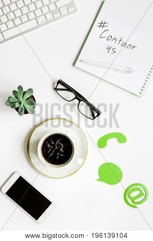 customer support company office with contact us text and signs on white desk background top view mockup