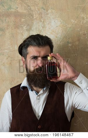 Man Posing With Bottle Of Red Liqueur