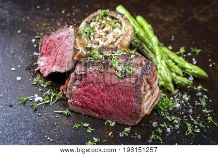 Barbecue Wagyu Point Steak with green Asparagus and Mushroom Cap as close-up on a rusty metal sheet