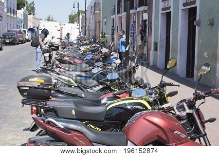 VALLADOLID YUCATAN MEXICO - FEBRUARY 24 2017: Inexpensive motorbikes are the personal means of transportation choosen by many citizens in Mexico