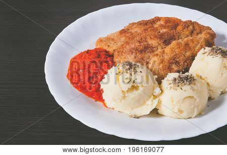 Plate of fresh, hot, crispy fried chickenand mashed potatoes on a wood table. Food concept.