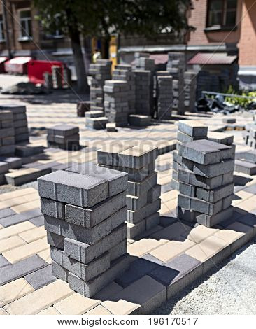 Laying of paving slabs on the construction site for the street pavement of the city