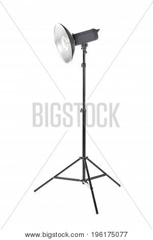Professional studio flashlight, isolated on a white background. Photographic studio light with a tripod. A reflector, an outbreak on a tripod. Photo equipment.