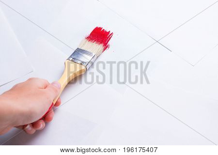 Construction Brush In Hand On White Background. Not Isolated