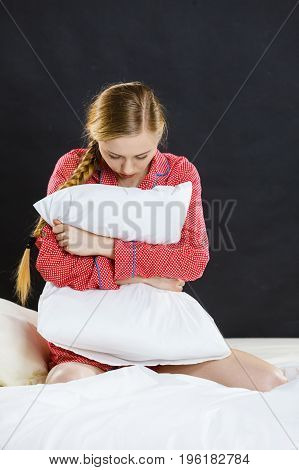 Sad Depressed Girl In Bed Gripping Pillow