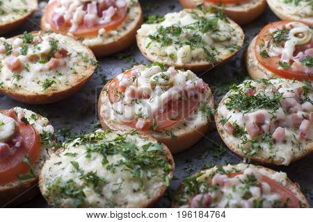 Mini pizza on ready-made buns with tomatoes and sausage