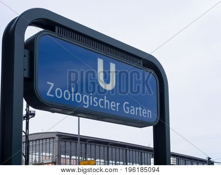 BERLIN GERMANY - JULY 19 2017: Sign of Metro Station Zoologischer Garten With Train Station In The Background In Berlin
