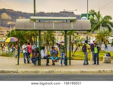 GUAYAQUIL, ECUADOR, NOVEMBER - 2016 - Group of people at stop bus in Guayaquil outskirt Ecuador