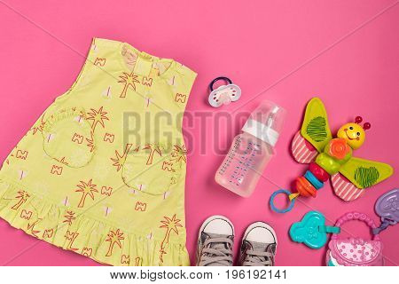 Baby clothes and accessories on pink background. Top view. Copy space. Still life. Flat lay