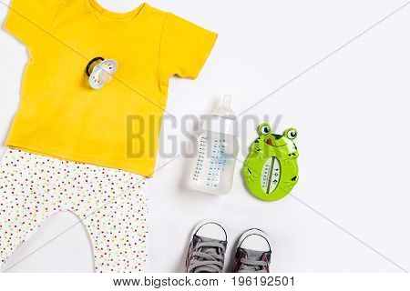 Baby clothes and accessories on white background. Top view. Copy space. Still life. Flat lay