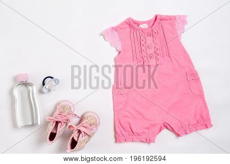 Baby clothes and accessories on white background. Top view. Copy space. Still life. Flat lay