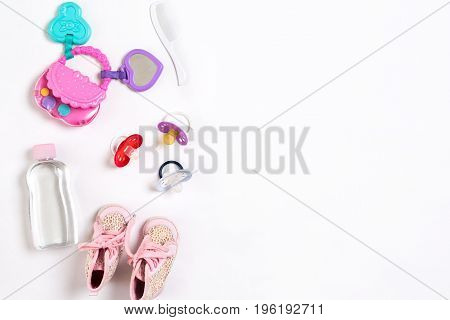 Baby footwear and accessories on white background. Top view. Copy space. Still life. Flat lay