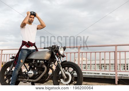 Brutal Man Near His Cafe Racer Custom Motorbike.
