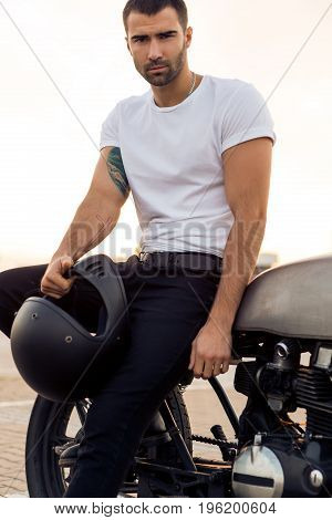 Brutal Man Sit On Cafe Racer Custom Motorbike.