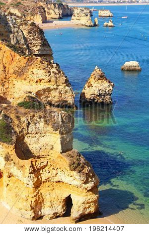 Camilo beach and rocky sea coast in Lagos, Algarve, Portugal
